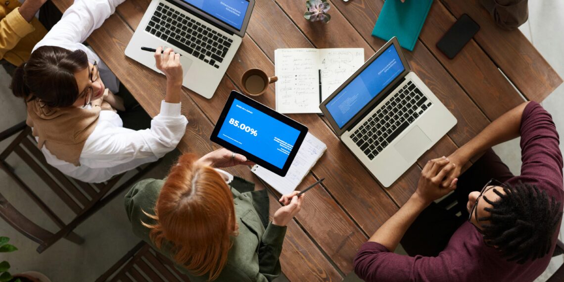 A co-living lounge with people working on laptops